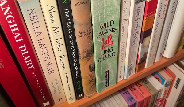 Dusty books on a bookshelf